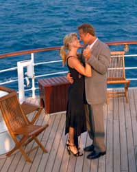 <strong>Cruise Ship Band: Lounge, Jazz and Party . A couple dance on deck in the evening sunset.</strong>